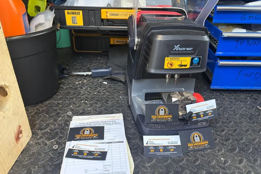 Xhorse automatic key cutting machine in the van with SOS business cards