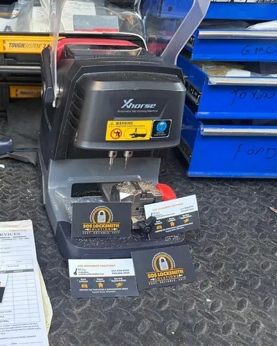 Xhorse automatic key cutting machine in the van with SOS business cards