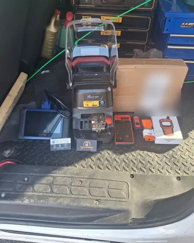 Key cutting machine and key programming tools in the back of the van
