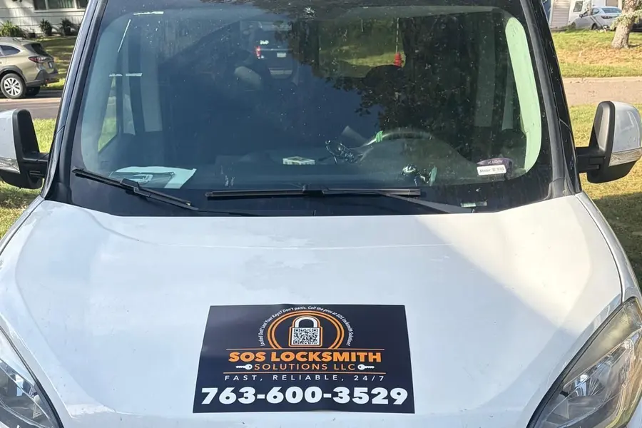 SOS Locksmith Solutions magnet with 763-600-3529 on the hood of the van