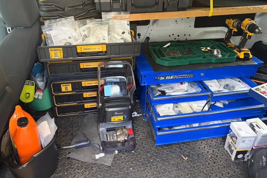 Inside the SOS van: drawers of lock parts, cordless drills and a key machine
