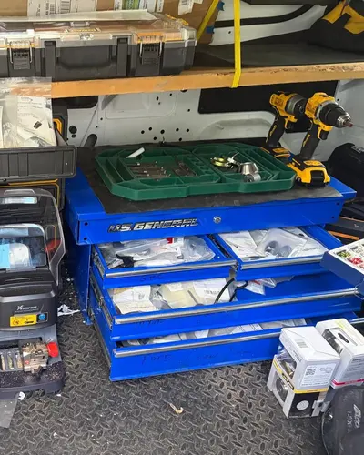 Inside the SOS van: drawers of lock parts, cordless drills and a key machine
