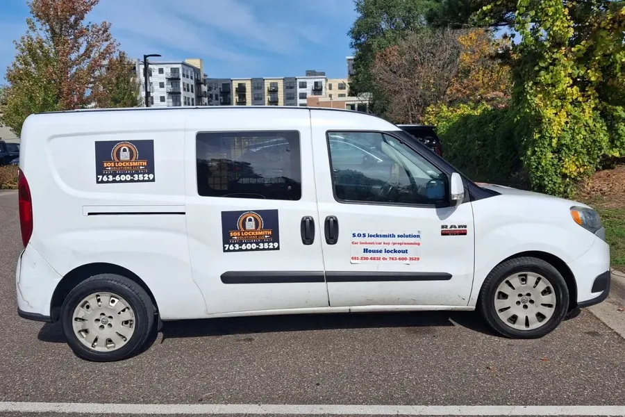 White RAM ProMaster City van with SOS Locksmith Solutions magnets showing 763-600-3529