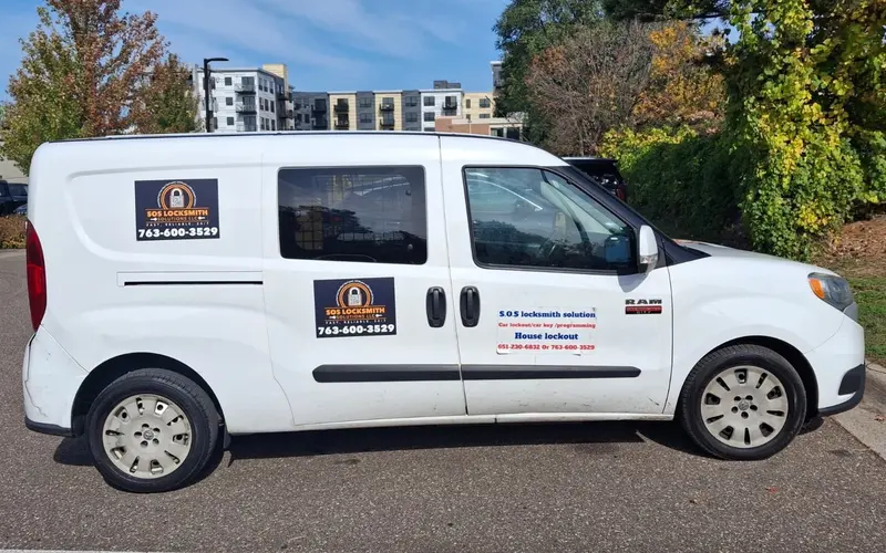 White RAM ProMaster City van with SOS Locksmith Solutions magnets showing 763-600-3529