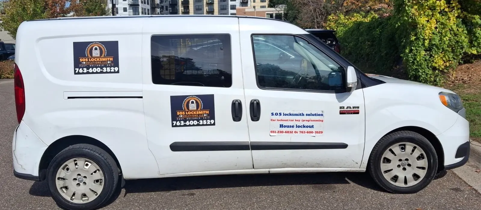 White RAM ProMaster City van with SOS Locksmith Solutions magnets showing 763-600-3529